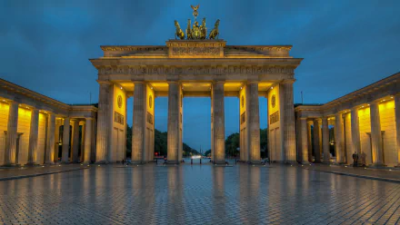 A stunning view of the Brandenburg Gate in Berlin, illuminated at dusk, showcasing its architectural grandeur as a prominent monument in Germany. 4K Ultra HD desktop wallpaper.