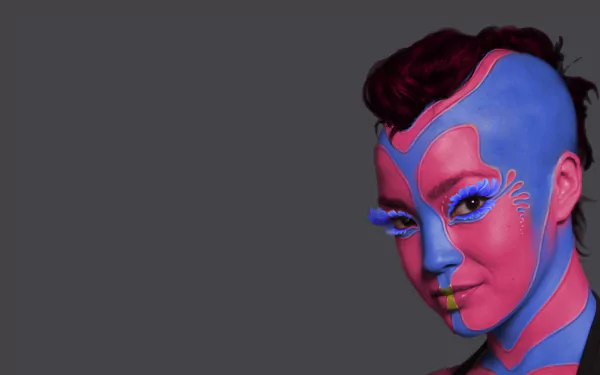A close-up 4K Ultra HD PC wallpaper of a character with blue and pink face paint, inspired by the movie Star Trek Into Darkness.