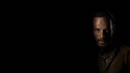 4K Ultra HD desktop wallpaper featuring a dark, intense close-up of a character from the TV show The Walking Dead against a black background.