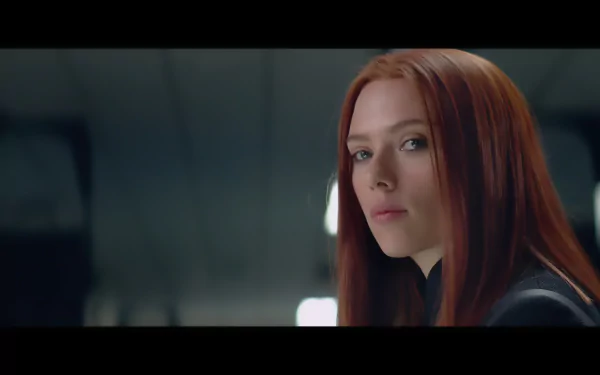 Scarlett Johansson as Black Widow in Captain America: The Winter Soldier, showcasing her fierce gaze in this HD desktop wallpaper. A captivating scene for any fan of the movie.