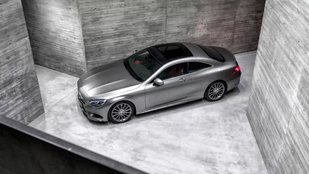 Mercedes-Benz S-Class Coupe in metallic silver, showcased in a minimalist concrete space, captured as an HD PC desktop wallpaper and background.