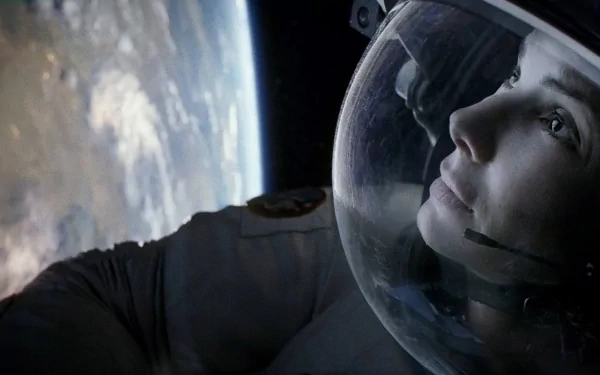 A captivating HD desktop wallpaper from the movie *Gravity* (2013), featuring an astronaut gazing out into space against a backdrop of Earth.