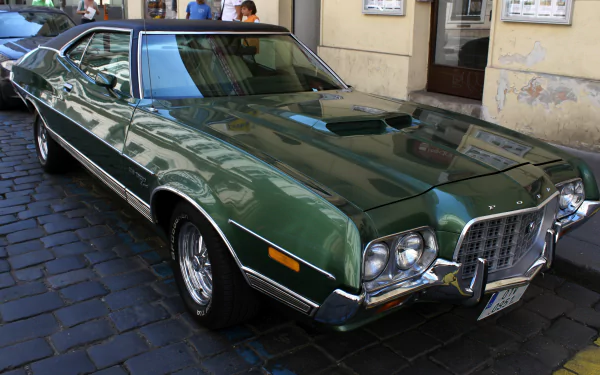A Ford Gran Torino in vibrant green parked on a city street, showcasing its classic design and chrome accents. Captured in 4K Ultra HD for stunning detail.