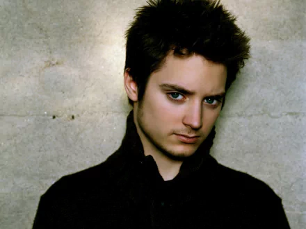 HD desktop wallpaper featuring a portrait of a man in a black shirt against a textured backdrop.