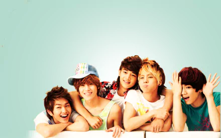 HD PC desktop wallpaper featuring SHINee members posing together against a light blue background, emphasizing music and vibrant energy.