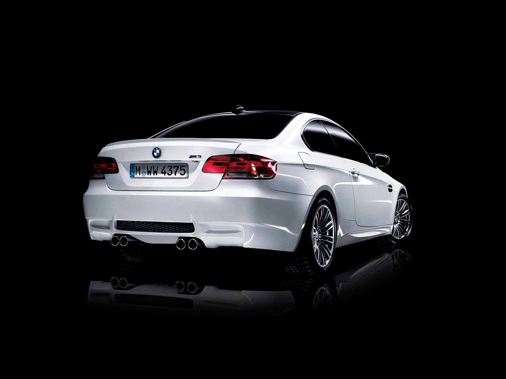 White BMW M3 sports coupe reflected on a glossy black surface — BMW vehicle showcased as an HD PC desktop wallpaper and background.