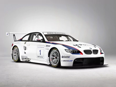 HD desktop wallpaper featuring a white BMW M3 GT2 race car with sponsor decals and detailed design against a plain background.