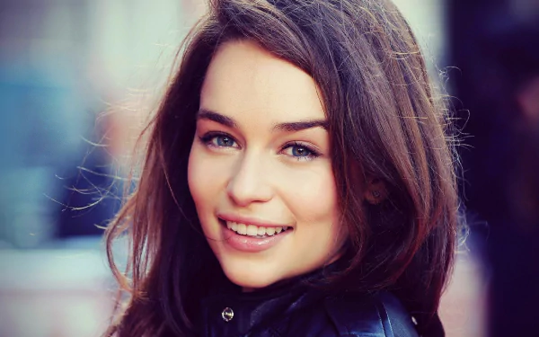 HD desktop wallpaper featuring a close-up of a brunette actress smiling warmly.