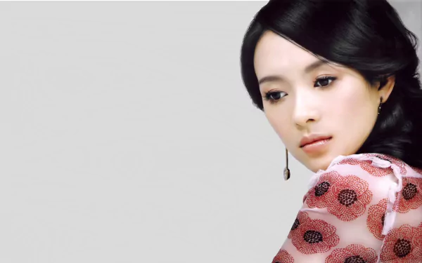 A stunning HD wallpaper featuring Chinese actress Zhang Ziyi, showcasing her elegant look with a floral-patterned outfit against a minimalist background.
