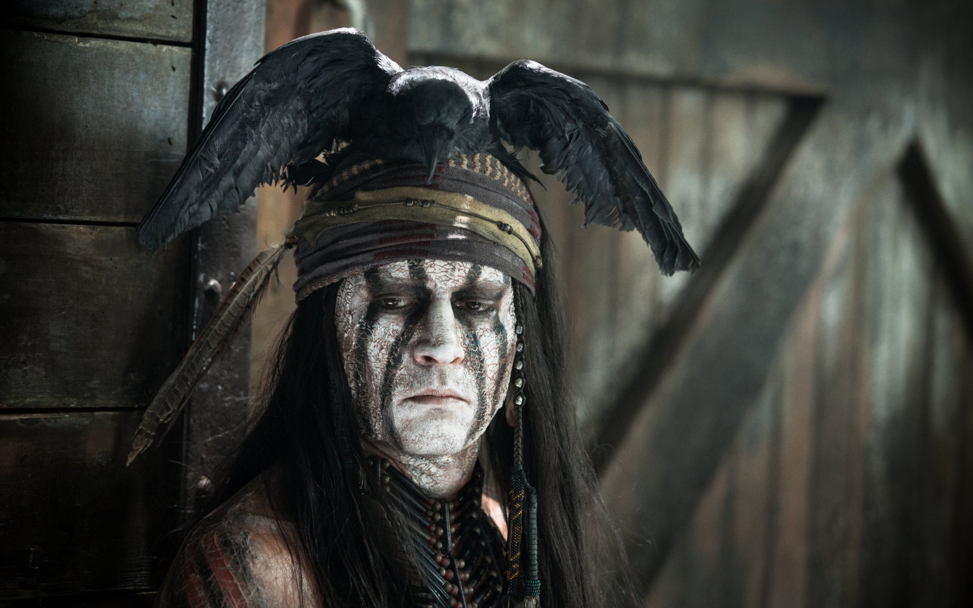 HD desktop wallpaper featuring Johnny Depp as Tonto from the movie The Lone Ranger, showcasing detailed costume and face paint with a dark, moody background.
