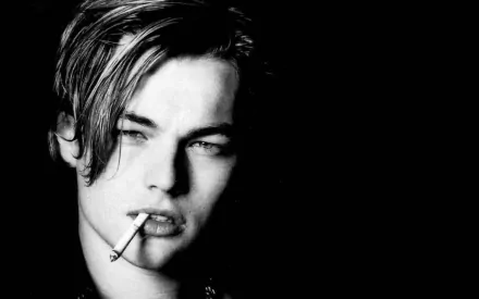 Black and white HD wallpaper featuring American actor and celebrity Leonardo DiCaprio with a cigarette, capturing a moody and intense expression.