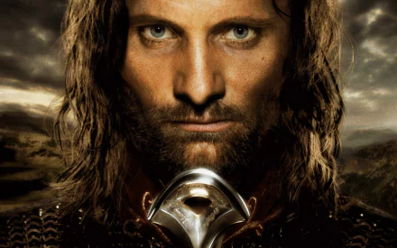 Close-up of Aragorn from *The Lord of the Rings: The Return of the King*, showcasing his intense gaze and warrior armor, set against a dramatic background. High-definition desktop wallpaper.