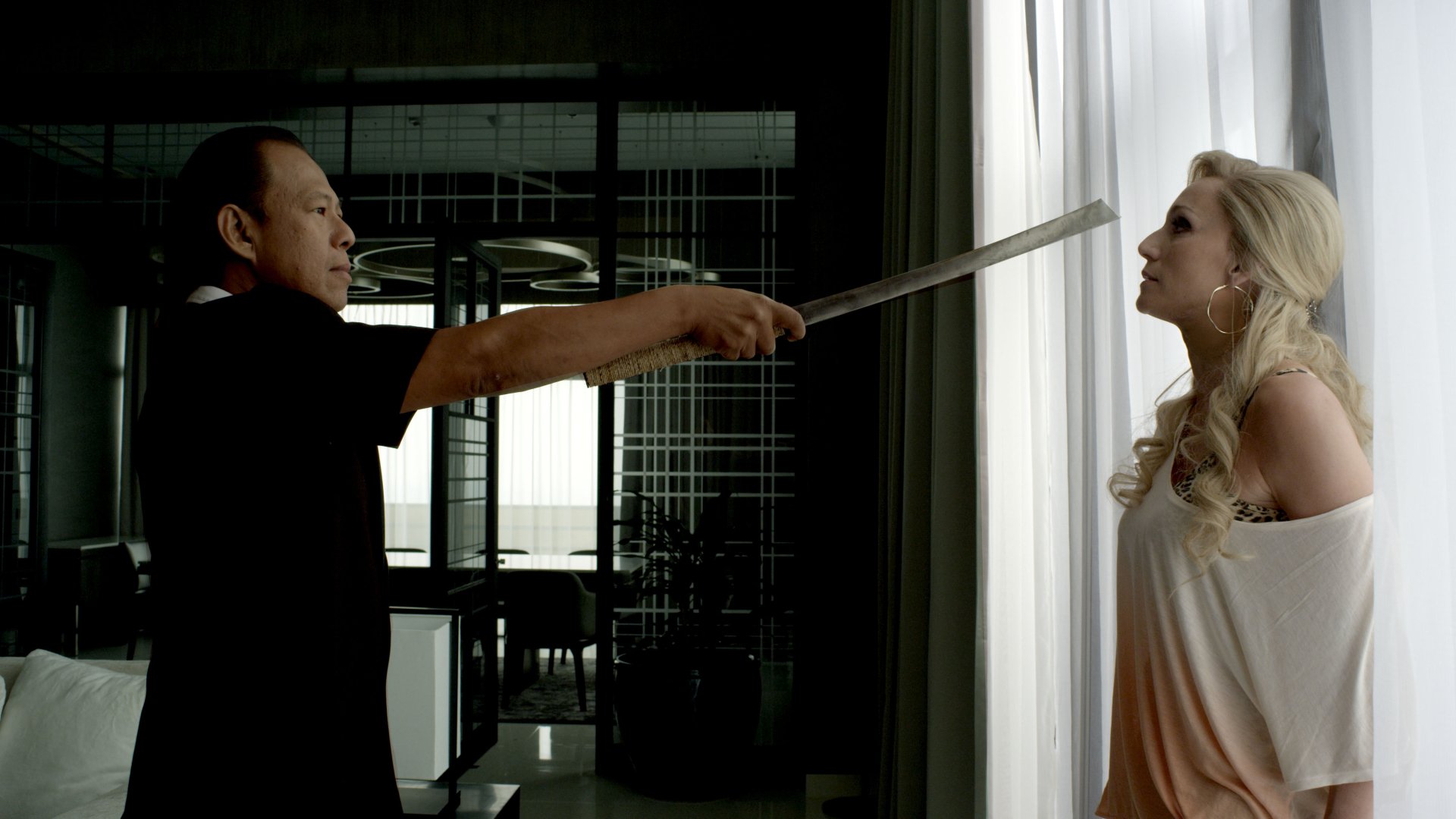 Scene from the movie Only God Forgives featuring Vithaya Pansringarm holding a sword to Kristin Scott Thomas, shown in 4K Ultra HD PC desktop wallpaper quality.