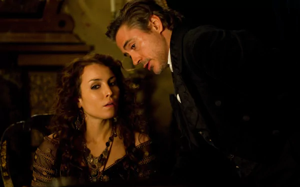 A dramatic scene from Sherlock Holmes: A Game of Shadows featuring Noomi Rapace and Robert Downey Jr., showcasing the intriguing dynamics between their characters.