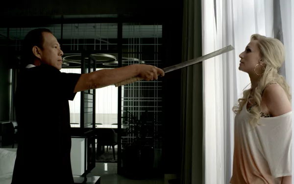 Scene from the movie Only God Forgives featuring Vithaya Pansringarm holding a sword to Kristin Scott Thomas, shown in 4K Ultra HD PC desktop wallpaper quality.