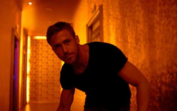 HD desktop wallpaper featuring Ryan Gosling in a dimly lit orange hallway from the movie Only God Forgives.