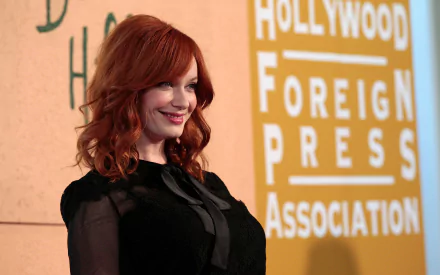HD desktop wallpaper featuring American actress and celebrity Christina Hendricks smiling against a backdrop with the Hollywood Foreign Press Association logo.