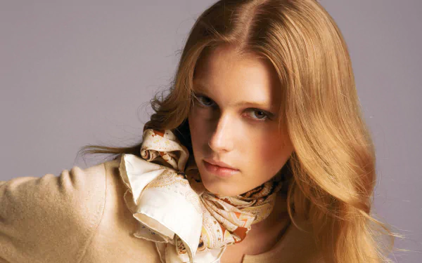HD desktop wallpaper featuring French model Sigrid Agren with flowing blonde hair and a stylish scarf against a neutral background.