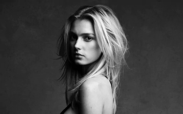 Black and white HD desktop wallpaper featuring French model Sigrid Agren looking over her shoulder against a dark background.