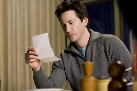 Actor from the movie The Lake House reads a letter at a table; moody 2K Quad HD PC desktop wallpaper/background.