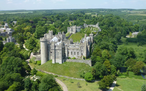 Aerial view of the man-made Arundel Castle surrounded by lush greenery, captured in high definition as a PC desktop wallpaper and background.