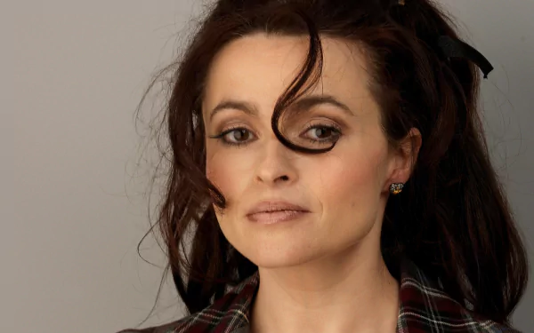 HD desktop wallpaper featuring a close-up portrait of English actress and celebrity Helena Bonham Carter with dark hair and a neutral expression.