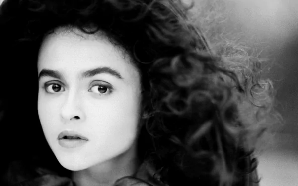 Black and white HD desktop wallpaper featuring English actress and celebrity Helena Bonham Carter with curly hair and a captivating expression.