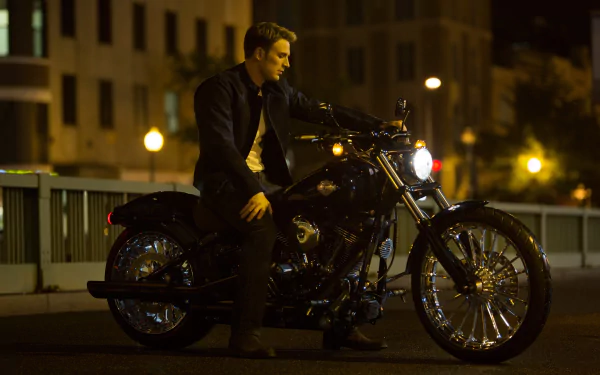 Steve Rogers, portrayed by Chris Evans, sits on a Harley-Davidson motorcycle in a nighttime setting from the movie Captain America: The Winter Soldier, featured as a HD desktop wallpaper.