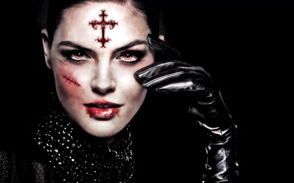 A dark fantasy HD desktop wallpaper featuring a gothic woman with red eyes, facial scars, a red occult cross on her forehead, and a black leather glove against a black background.