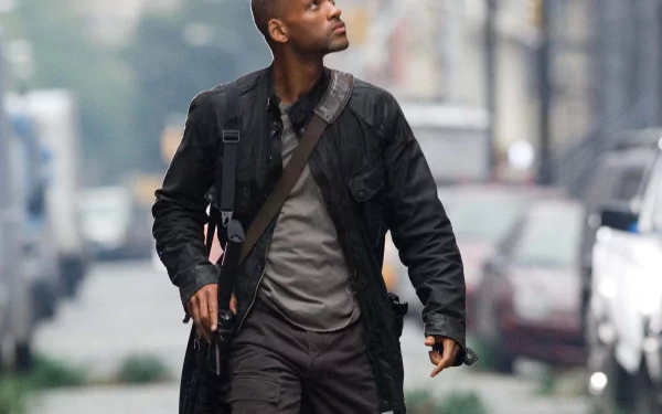 A powerful HD wallpaper from the movie *I Am Legend*, featuring the main character walking through an abandoned city street, exuding determination and resilience.