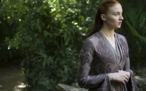 4K Ultra HD PC desktop wallpaper of a red-haired noblewoman in a medieval gown standing among lush foliage, hands clasped, contemplative pose evoking the Game of Thrones TV series.