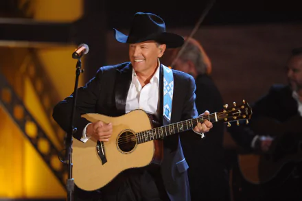 George Strait performing live with an acoustic guitar, captured in a vibrant 4K Ultra HD wallpaper showcasing his iconic cowboy hat and smile.