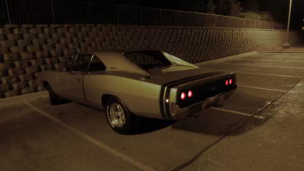 A Dodge Charger parked in a dimly lit area, showcasing its sleek design and distinctive rear lights, captured in high-definition for an impressive desktop wallpaper.