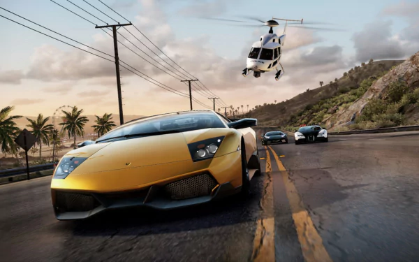 HD PC desktop wallpaper from the video game Need For Speed: Hot Pursuit, featuring a yellow sports car racing on a coastal road with a police helicopter in pursuit.
