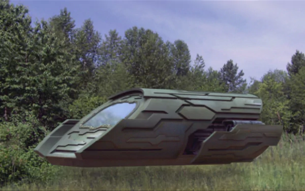 HD PC desktop wallpaper from the TV show Stargate Atlantis: a sleek gray Puddle Jumper shuttle hovering above a grassy clearing with trees under a blue sky.