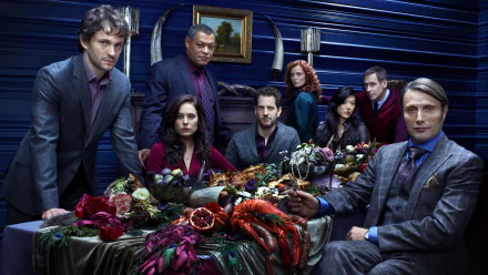 HD PC desktop wallpaper featuring the main cast of the TV show Hannibal gathered around a lavish, darkly styled dining table.