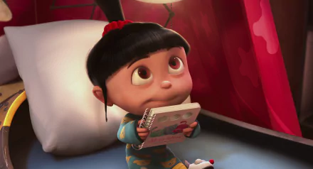 Agnes from Despicable Me sits on a bed, holding a book with curious eyes. HD desktop wallpaper tagged with movie and Despicable Me.