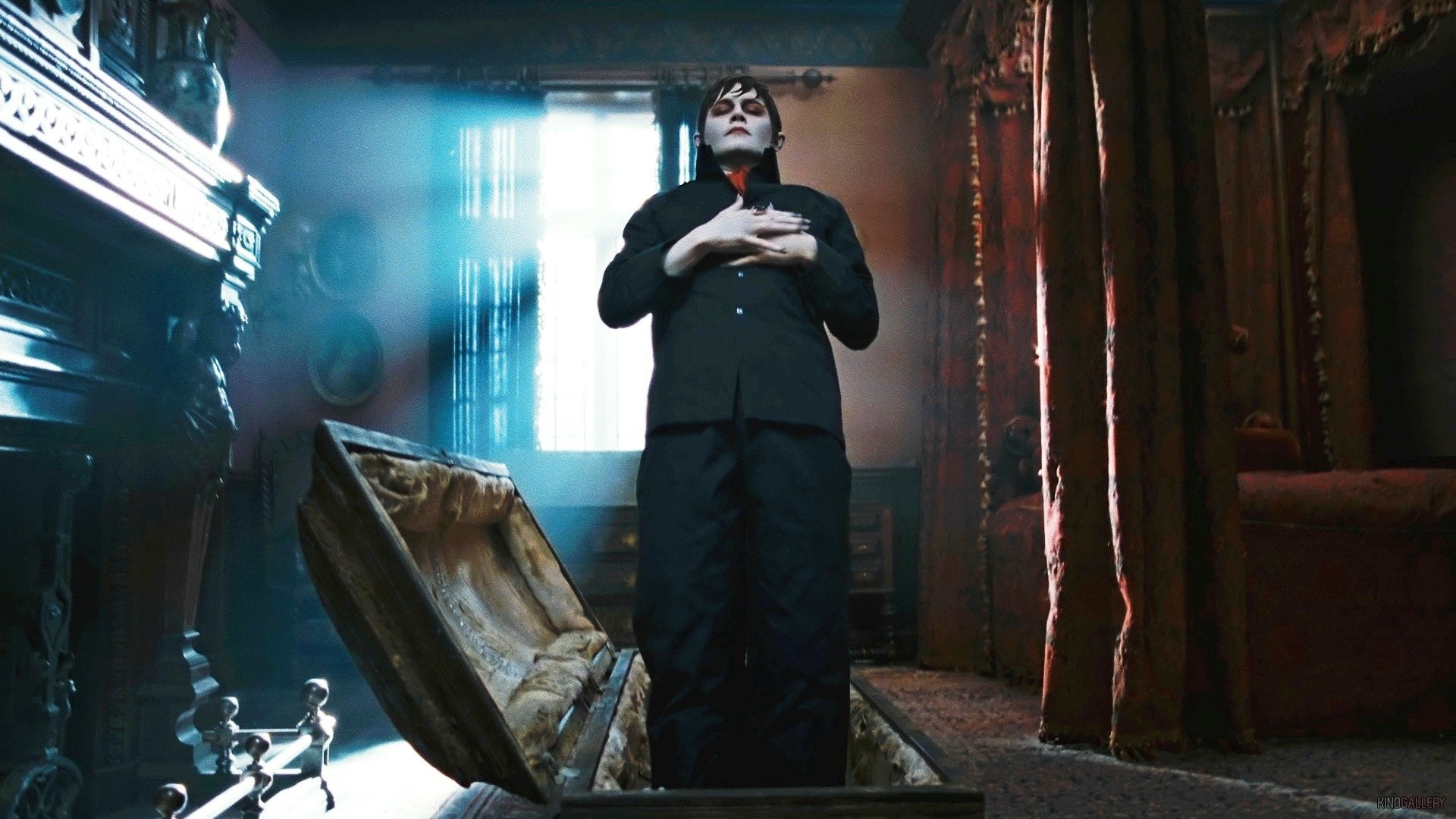 HD PC desktop wallpaper featuring Johnny Depp as Barnabas Collins in the movie Dark Shadows, standing in a dimly lit room with an open coffin.