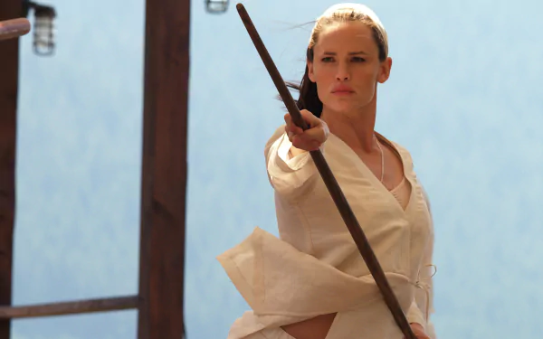 HD PC desktop wallpaper featuring Elektra from Marvel Comics in a poised martial arts stance, holding a staff against a minimalist background.