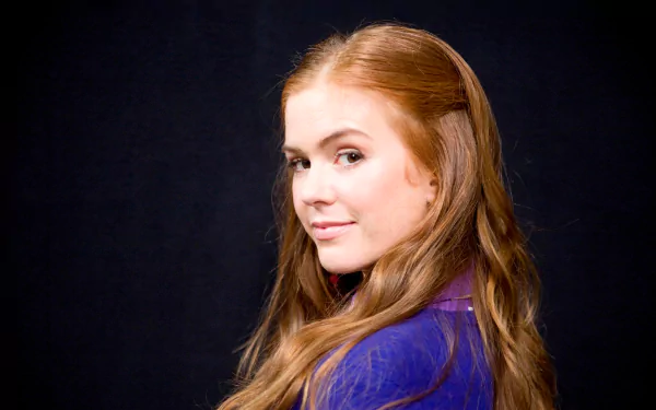 HD PC desktop wallpaper: studio portrait of a red-haired woman glancing over her shoulder against a dark background.