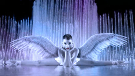 HD fantasy desktop wallpaper featuring a serene angel with expansive wings reclining gracefully in shimmering water against a backdrop of cascading fountains.