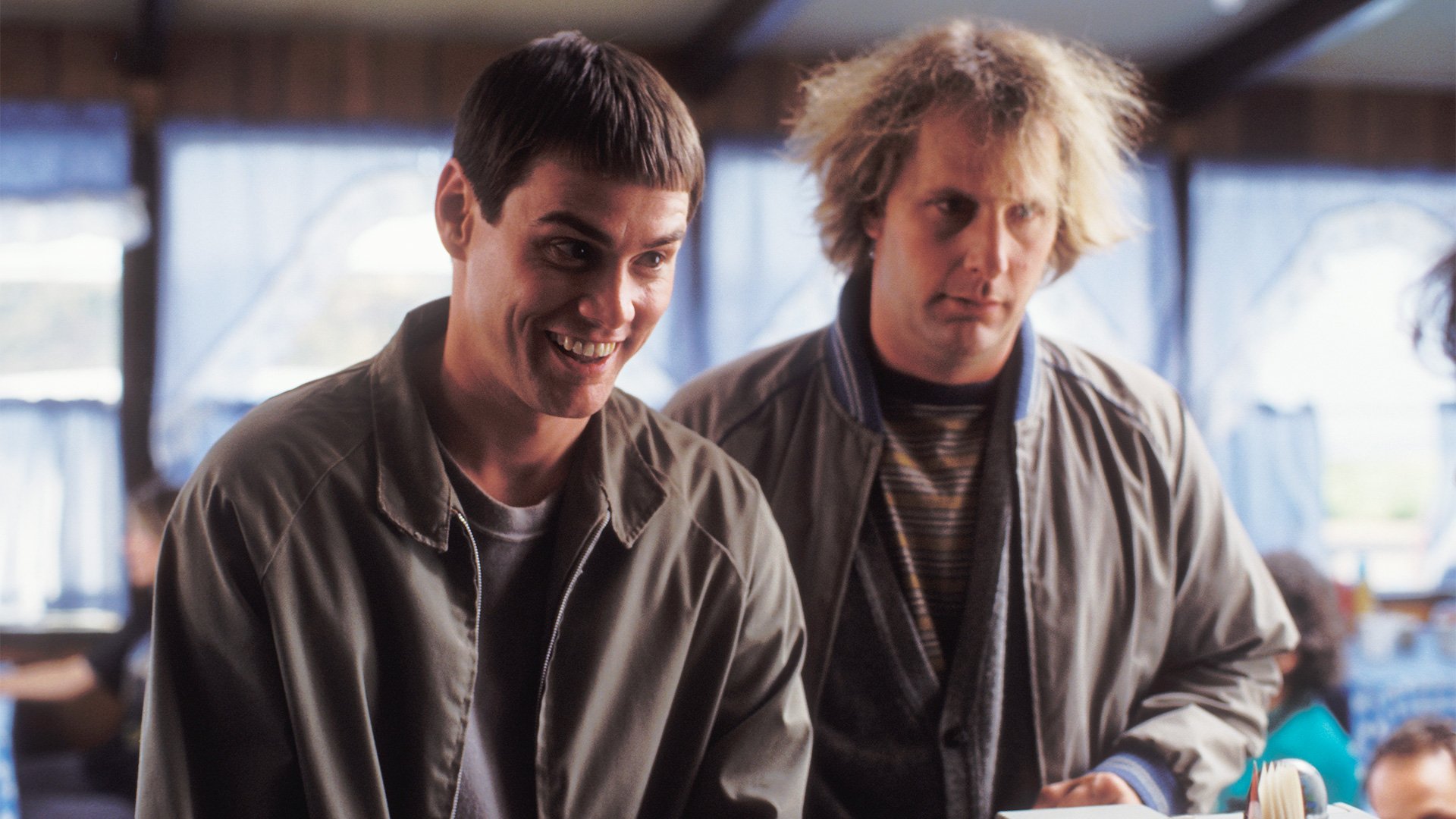 HD desktop wallpaper from Dumb and Dumber To featuring two men in casual attire with comically contrasting expressions.