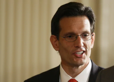 HD desktop wallpaper featuring a man in a suit against a blurred background.