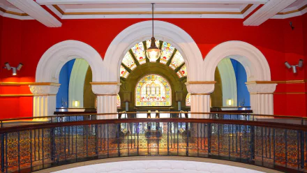 Stained glass window and elegant archway inside Sydney's Queen Victoria Building, showcasing intricate architecture and vibrant colors in this Australia landmark.