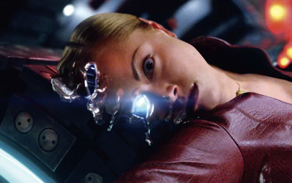 A close-up of a character from Terminator 3: Rise of the Machines, showcasing a dramatic moment with a glowing eye and liquid metallic elements. Suitable as a HD PC wallpaper and background.