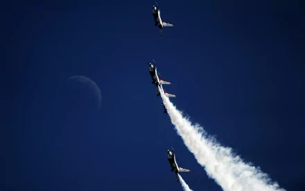 HD desktop wallpaper featuring three military aircraft performing a vertical smoke trail stunt during an air show against a deep blue sky with a faint moon.