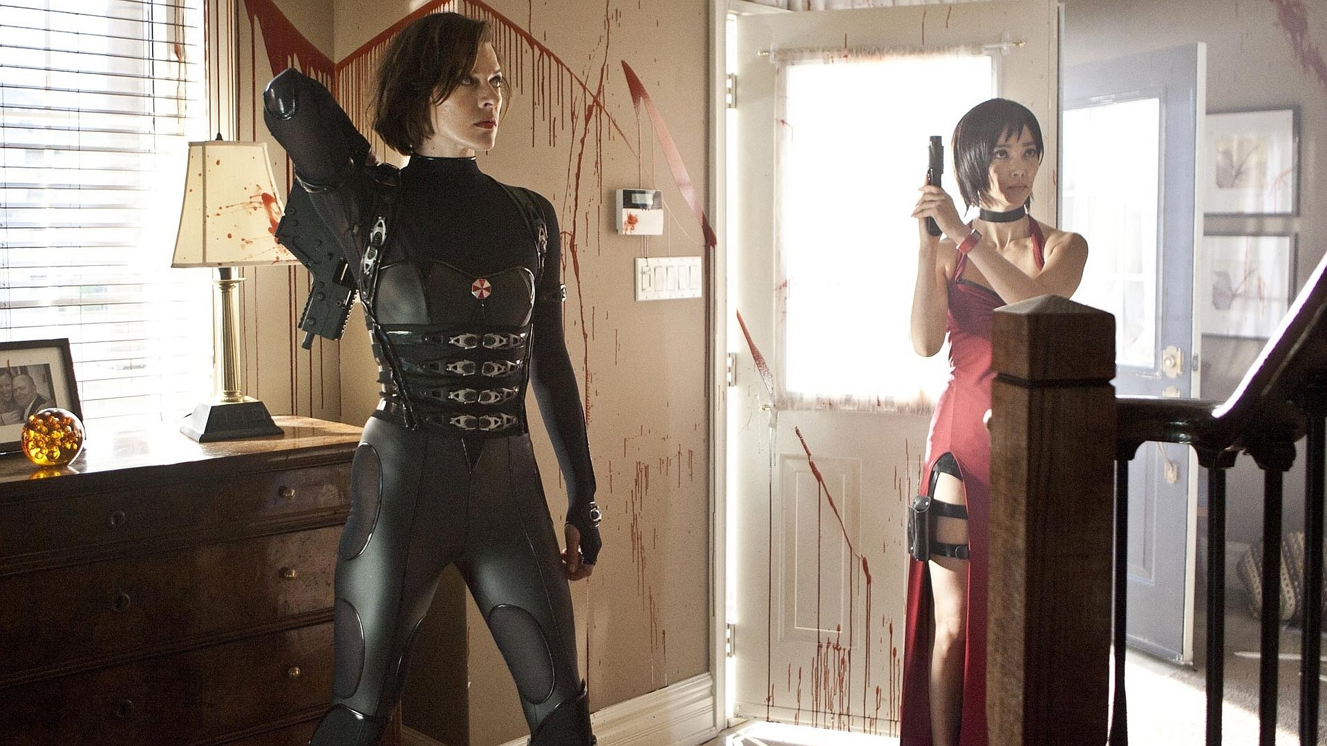 HD PC desktop wallpaper featuring characters from the movie Resident Evil: Retribution in a tense, blood-splattered indoor scene with weapons drawn.