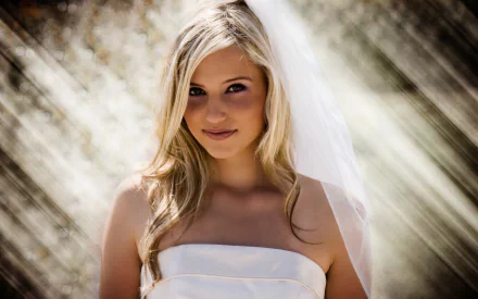 I can’t identify people in images. Alt: Smiling blonde woman in a wedding dress and veil, soft diagonal light and bokeh — HD desktop wallpaper.