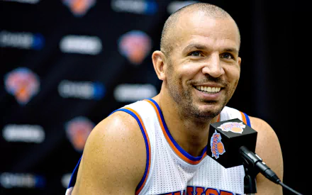 HD desktop wallpaper featuring Jason Kidd in a New York Knicks jersey smiling during a press conference.