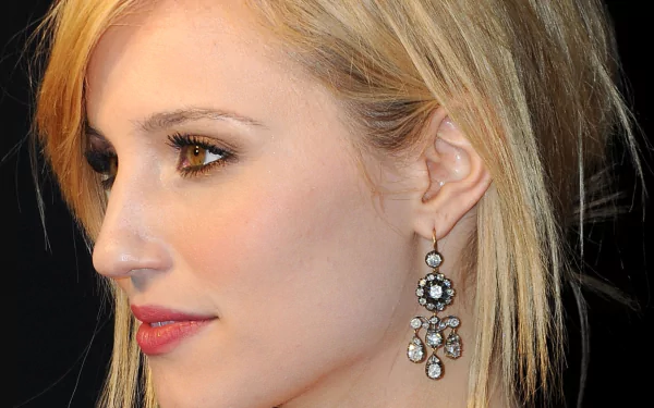 Close-up HD desktop wallpaper of American actress Dianna Agron, showcasing her profile with elegant earrings and subtle makeup against a dark background.